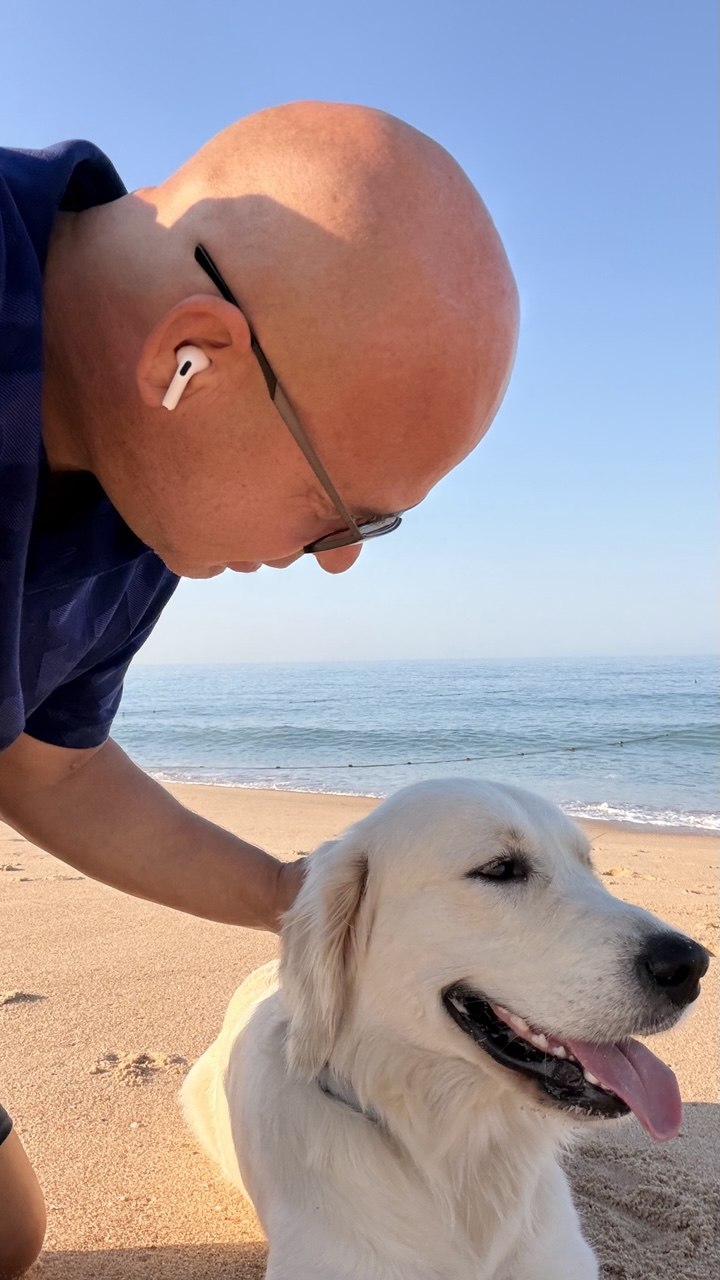 Rhett and his dog on a sunny beach